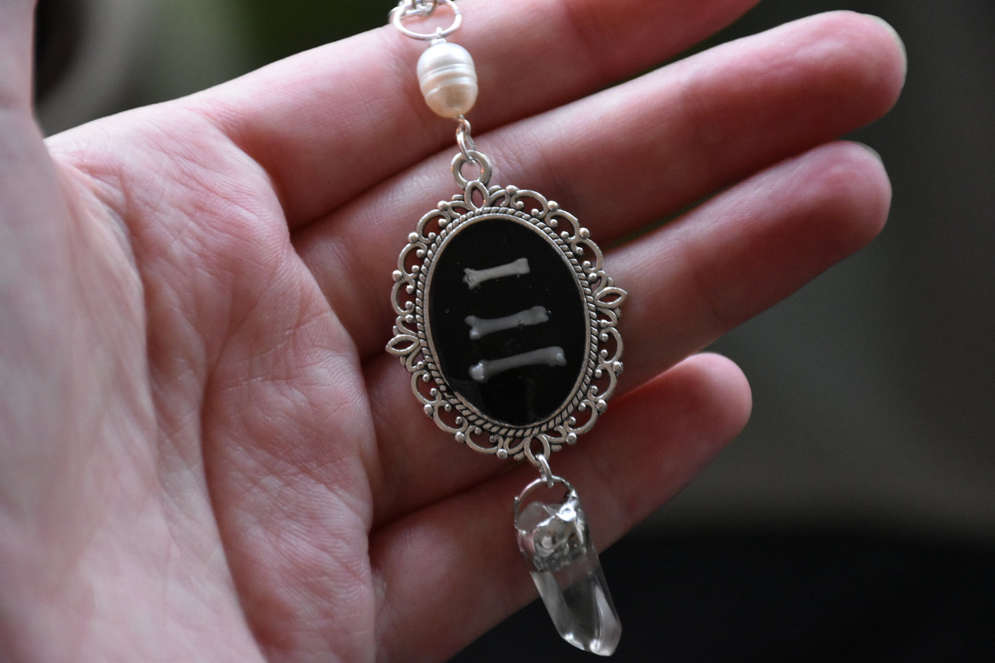 Black frame bone/tooth necklace clear quartz