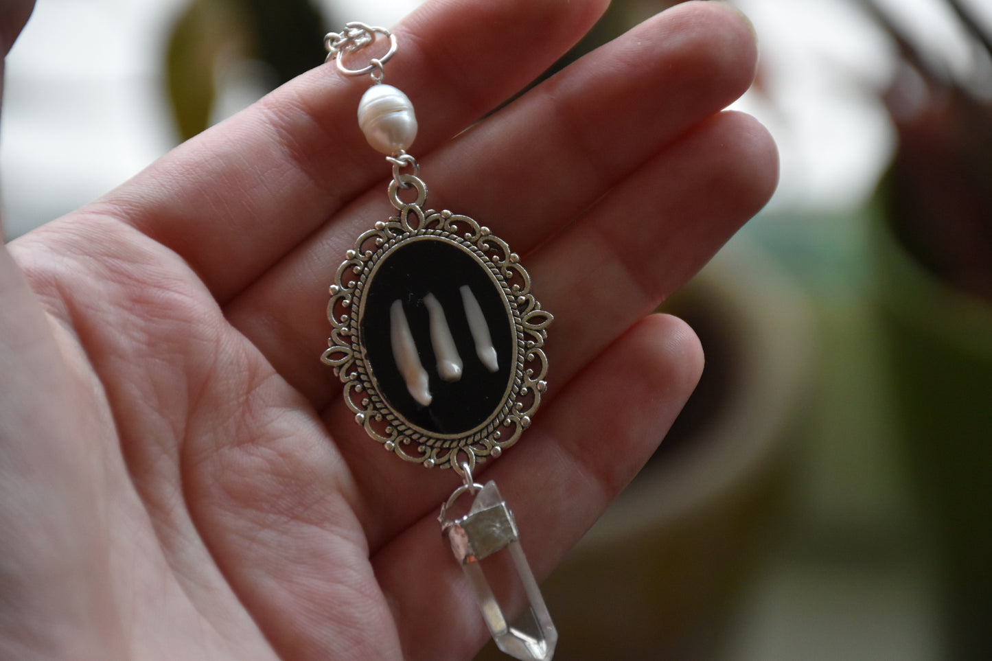 Black frame bone/tooth necklace clear quartz